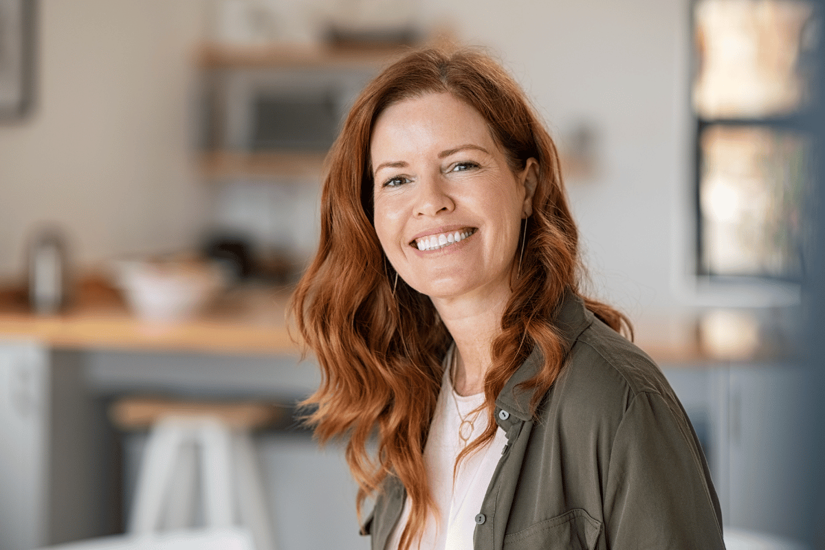a woman smiling and sitting at home