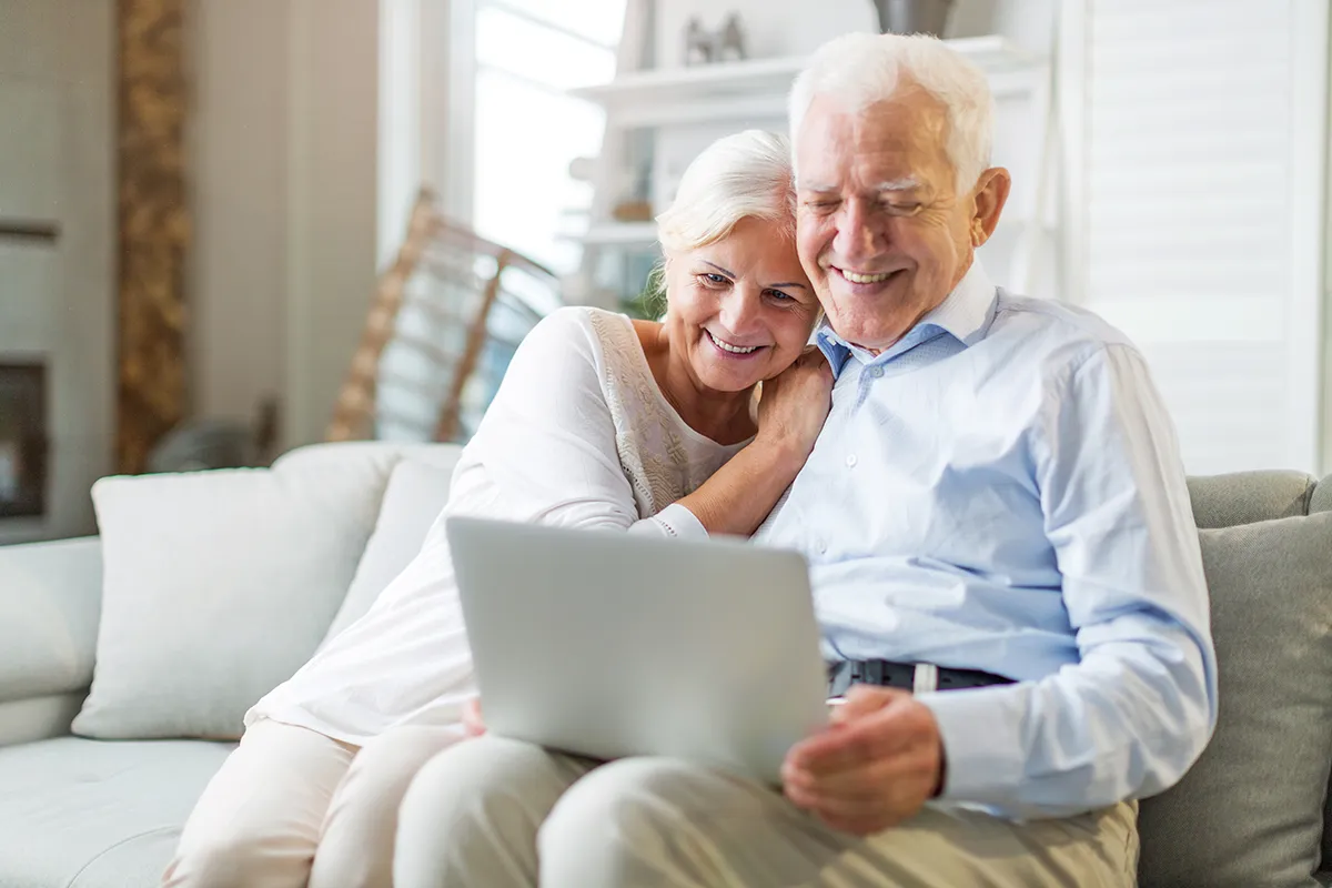 a senior couple using a computer at home